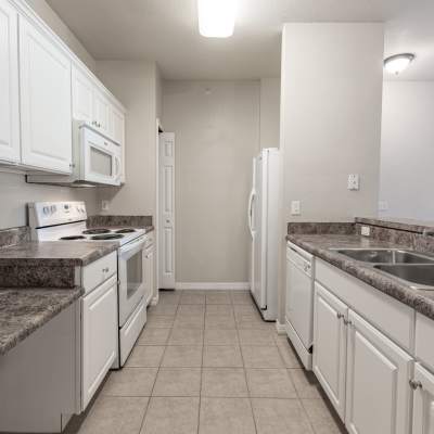 Kitchen with appliances and cabinets at Century Capital City in Tallahassee, Florida