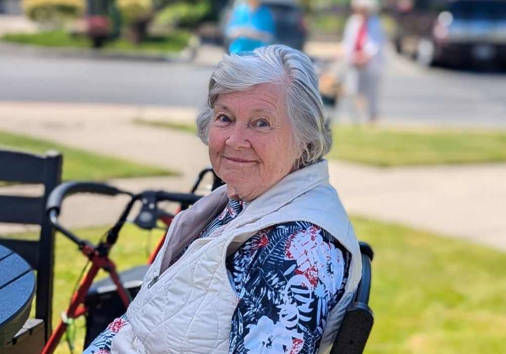 Resident sitting outside near Merrill Gardens at Tacoma in Tacoma, Washington