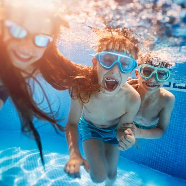 kids underwater in the pool at The Abbey at Copper Creek in San Antonio, Texas