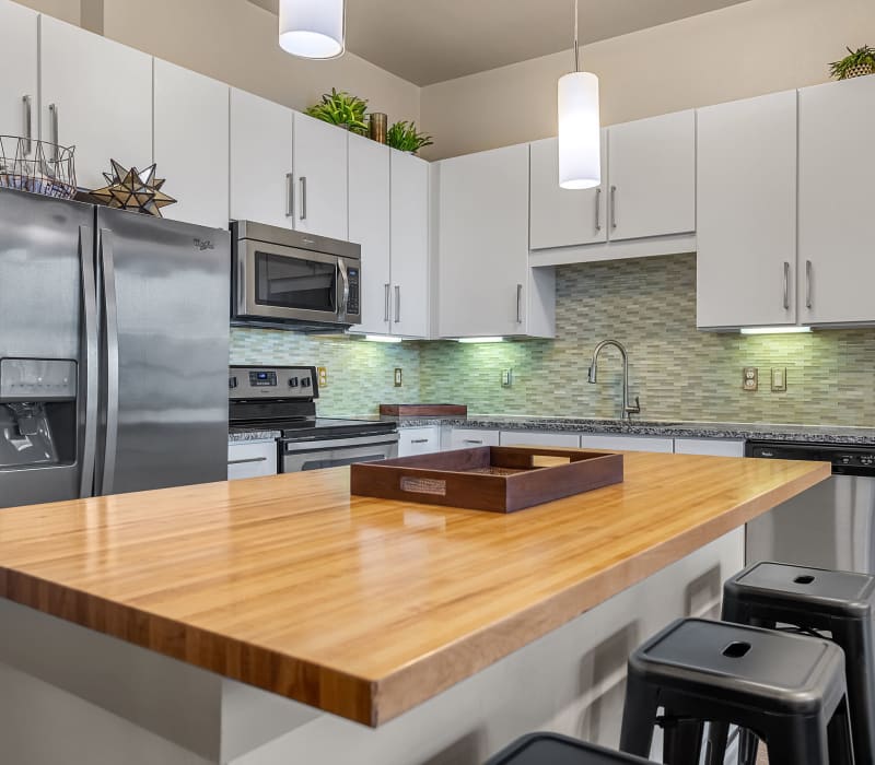 Spacious kitchen with kitchen island and counter stools at Marq Uptown in Austin, Texas