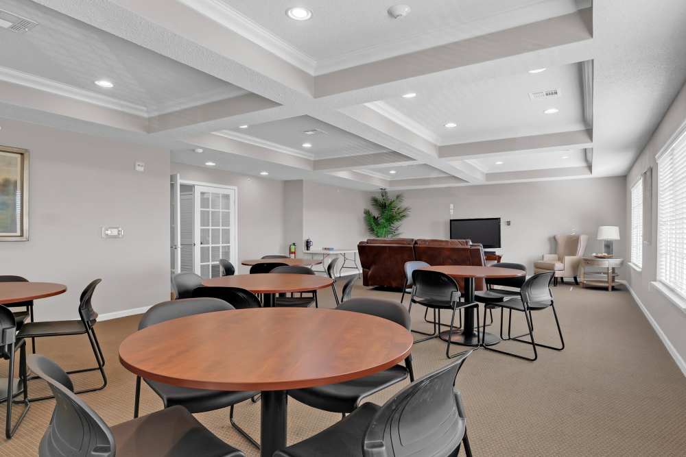 Community dining area with round table and chairs at River Ridge in Sand Springs, Oklahoma