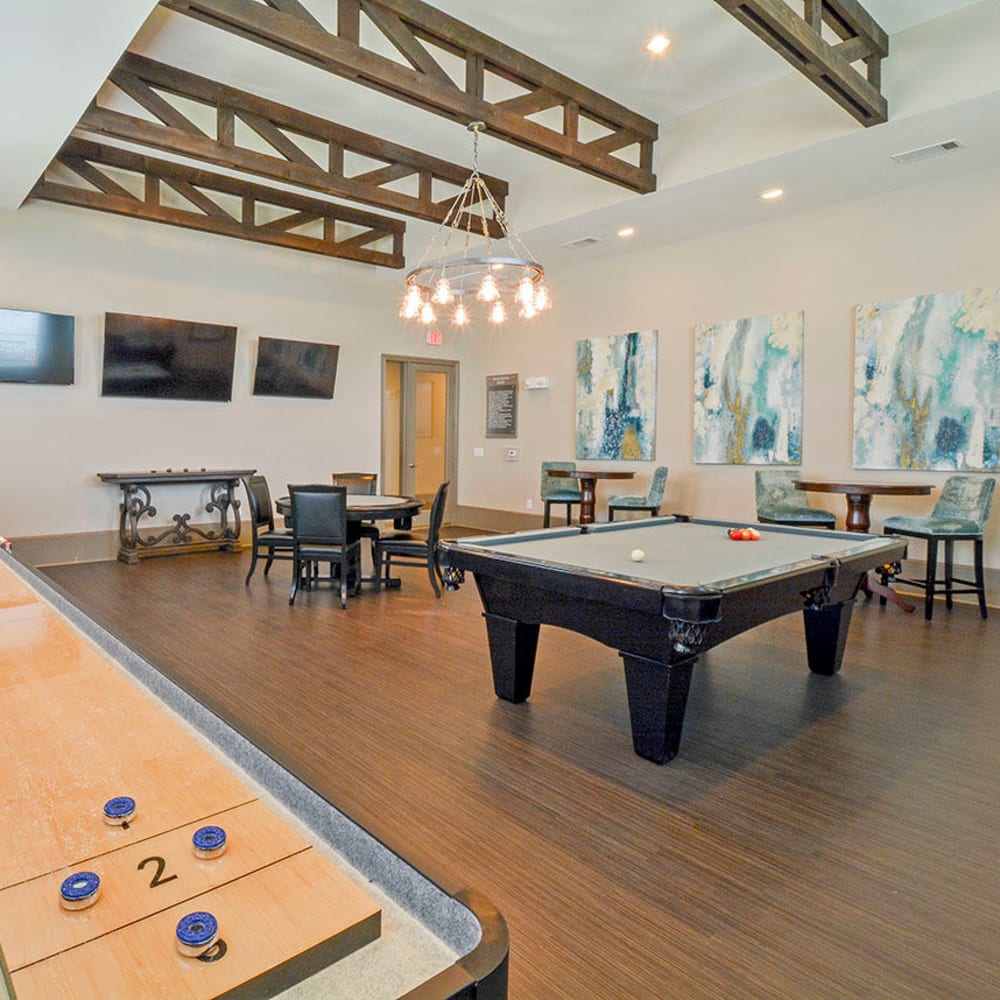 Game room with shuffleboard and pool table at Haven at Eldridge in Houston, Texas