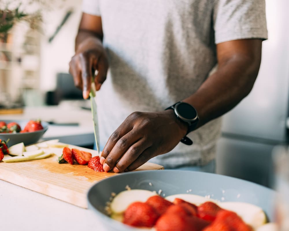 Man preparing dinner in his apartment at Shaff Square Apartments in Stayton, Oregon