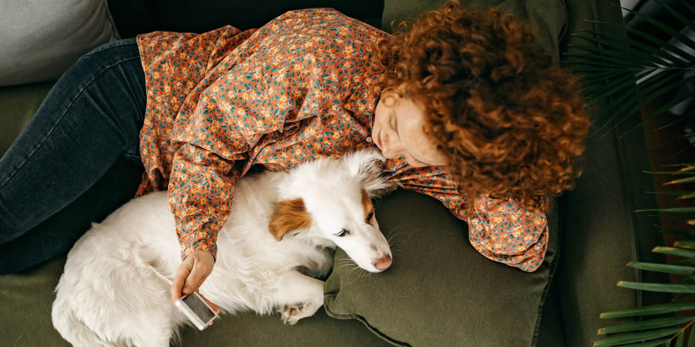 Resident cuddling their dog at Mark at West Midtown in Atlanta, Georgia