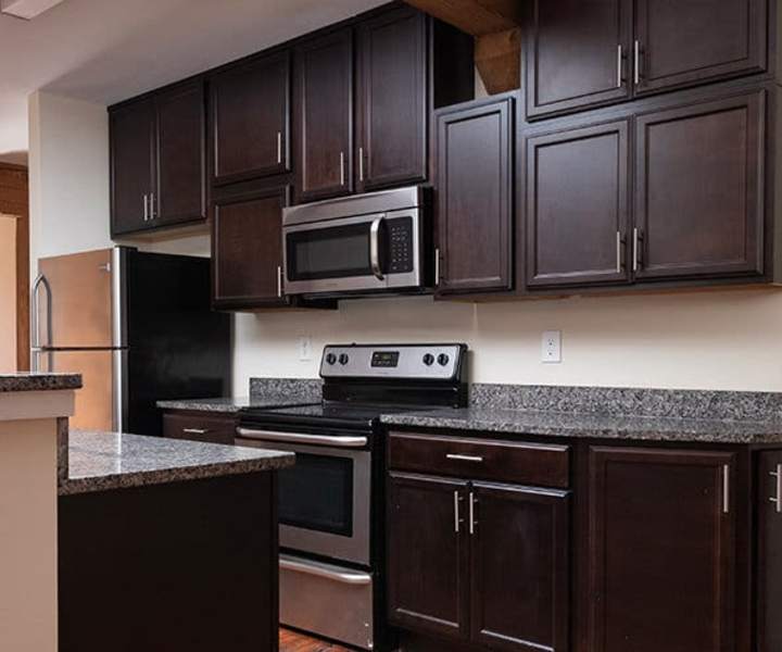 Stainless-steel appliances and wooden cabinets at High Street Lofts in Petersburg, Virginia