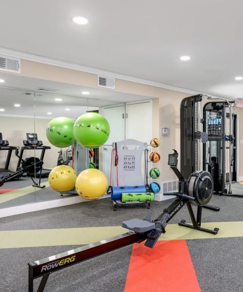 State-of-the-art fitness center with a rowing machine at Farmington Oaks Apartments in Farmington, Michigan