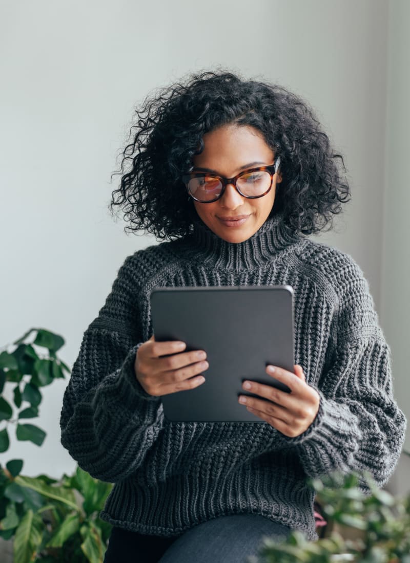 Resident working on her tablet at Marquis of Carmel Valley in Charlotte, North Carolina