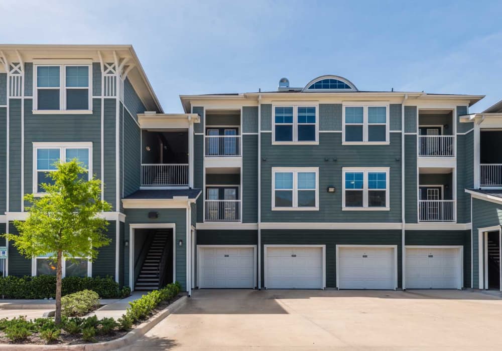 Exterior building with garage doors and green lawn at Southfork Lake in Manvel, Texas
