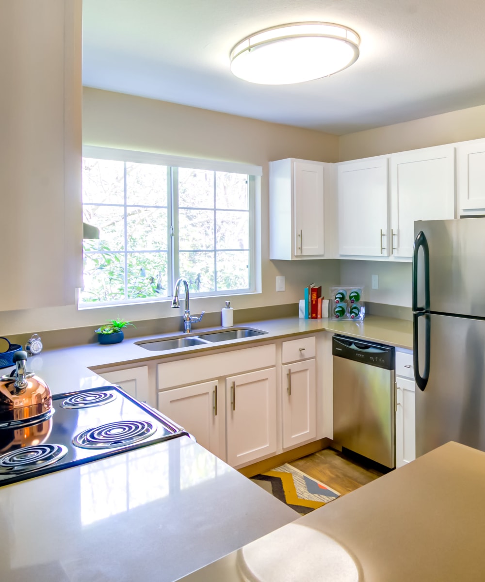 Model home's kitchen with quartz countertops and ample natural light at Sofi at Murrayhill in Beaverton, Oregon