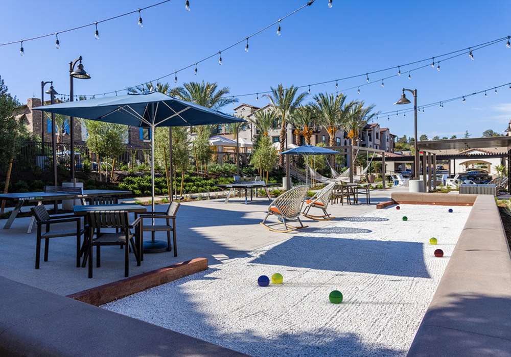 Bocce ball court with seating area for community at The Courtyards Pacific Village in San Diego, California