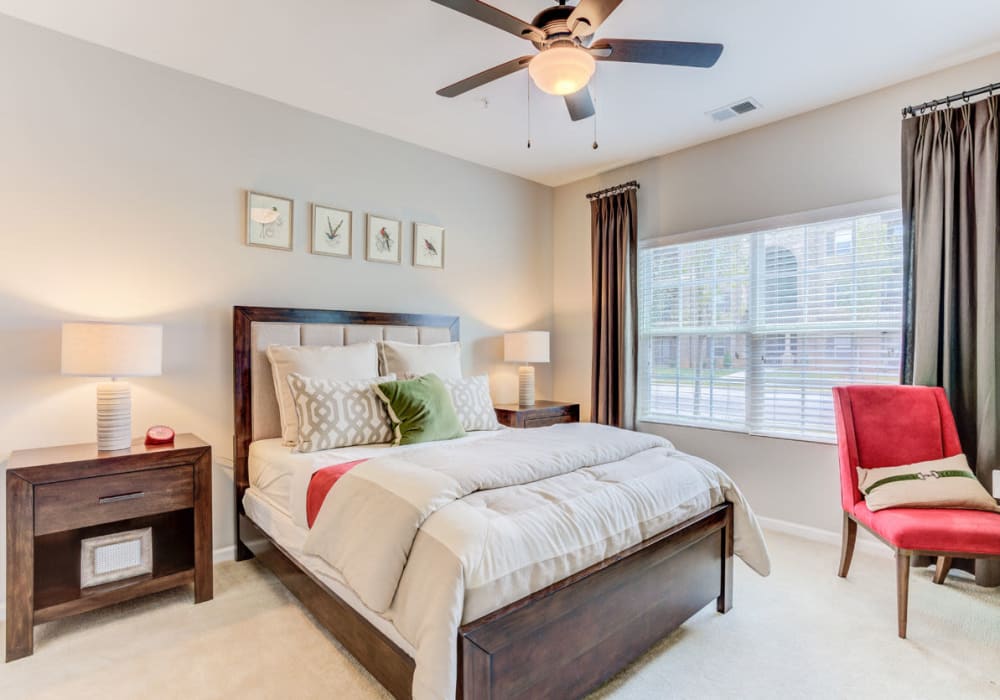 Comfortable bedroom with carpet at Bacarra Apartments in Raleigh, North Carolina