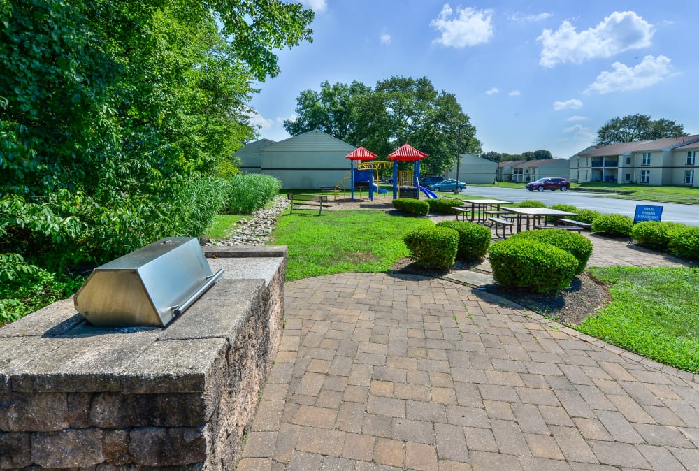 BBQ grilling stations, picnic area, and playground at Willowbrook Apartments in Jeffersonville, Pennsylvania