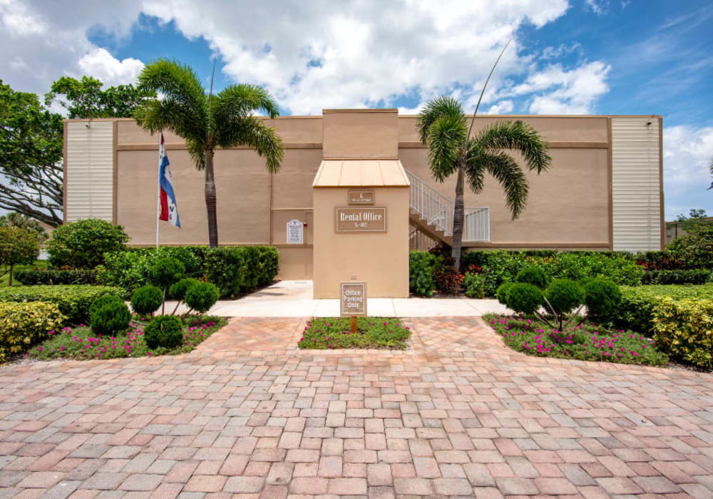 The front entrance with palm trees at Lime Tree Village in Deerfield Beach, Florida