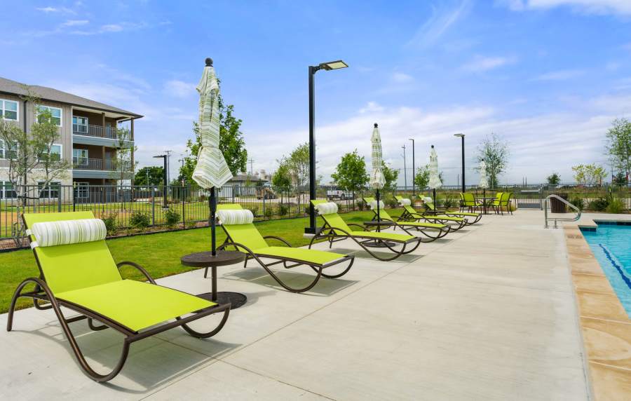 Poolside lounge chairs and sundeck at Walnut Springs in Seguin, Texas