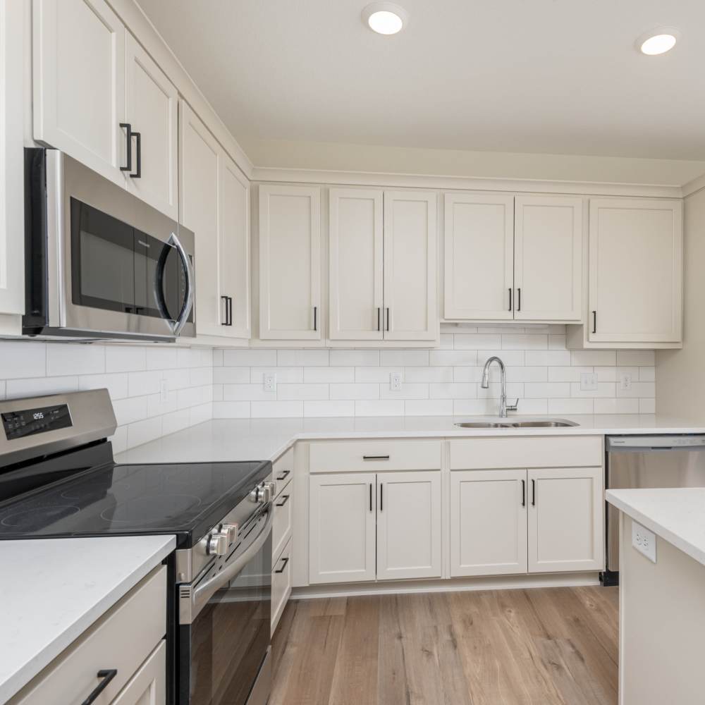 Kitchen with stainless-steel appliances at The Uptown Apartments in Waconia, Minnesota