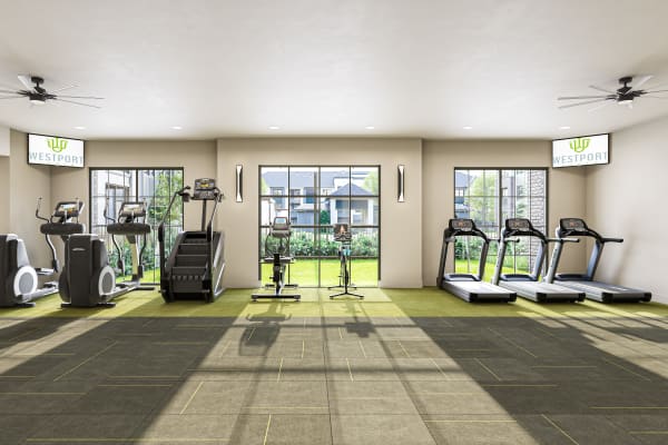 A row of treadmills facing a window in the fitness center at Westport Lofts in Belville, North Carolina