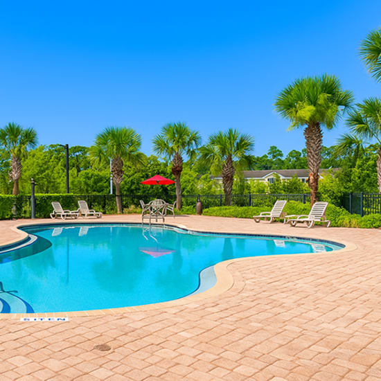 A resort style swimming pool with sparkling clean water at The Reserve at Brookhaven in Palm Coast, Florida 