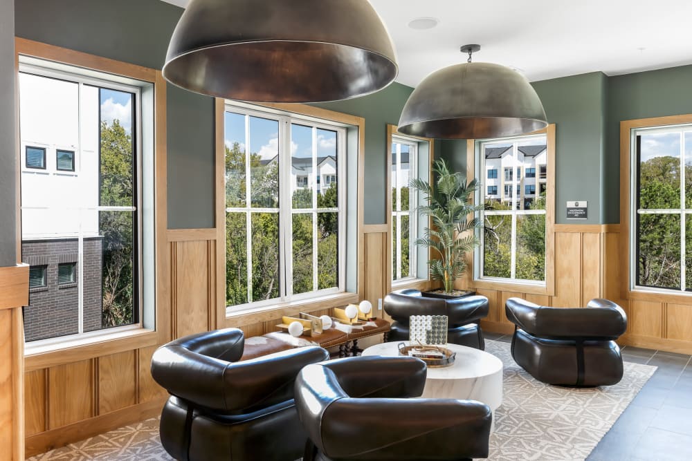 Speakeasy lounge with seating and card game table at The Bennett in Austin, Texas