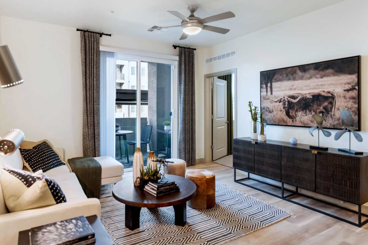 Model apartment with wood-style flooring and a ceiling fan at Hangar at Thunderbird, Glendale, Arizona