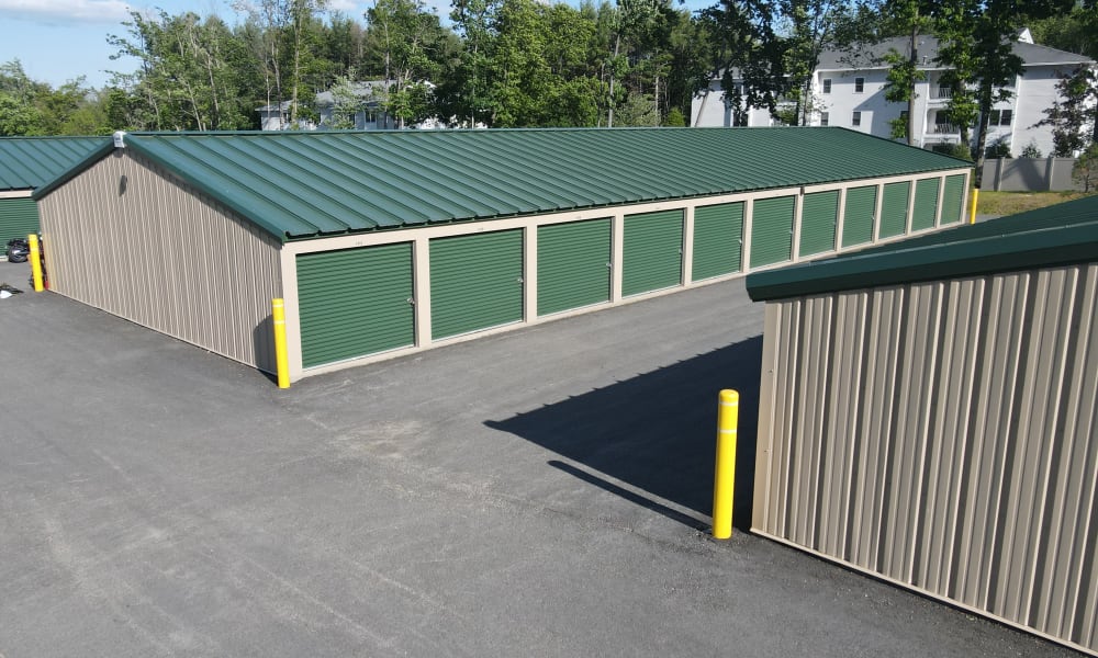 A row of outdoor units with green doors at 603 Storage - East Milford in Milford, New Hampshire
