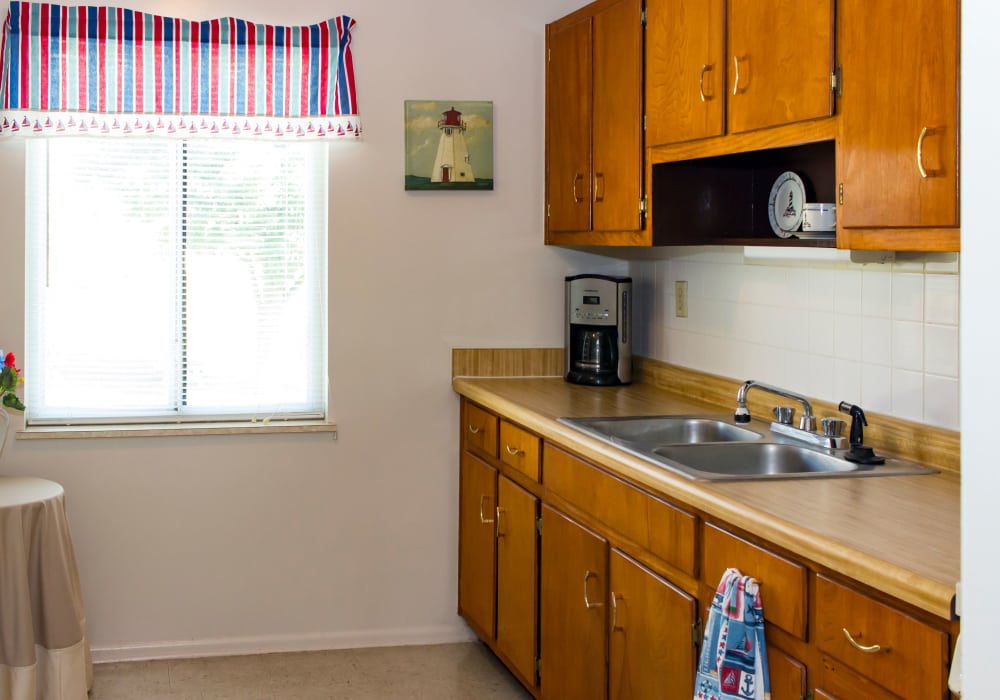 Kitchen with appliances and cabinets at Pin Oak Manor Apartments in Mishawaka, Indiana