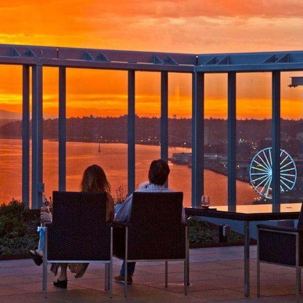 Couple enjoying the views from the rooftop lounge at The Wave at Stadium Place in Seattle, Washington