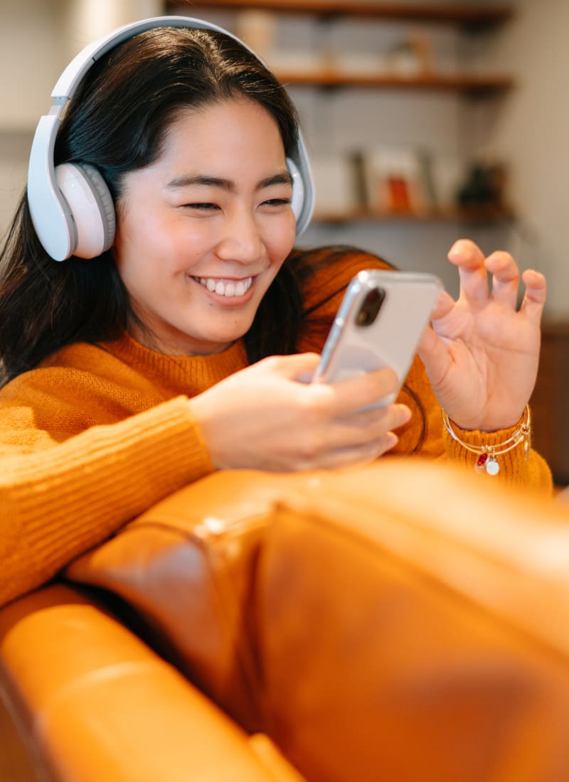 Resident with headphones listening to music at Fort Worth, Texas from Marquis at Bellaire Ranch