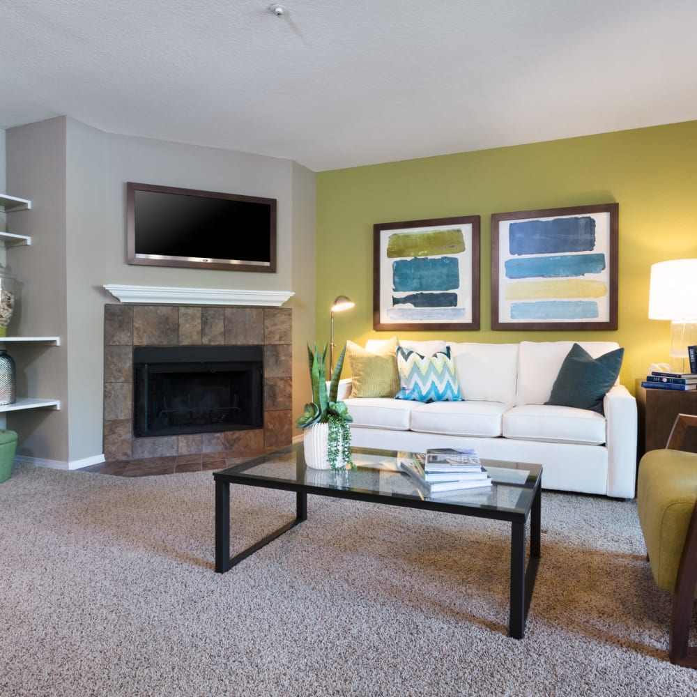 Open-concept living areas with plush carpeting in a model home at Timbers at Tualatin in Tualatin, Oregon