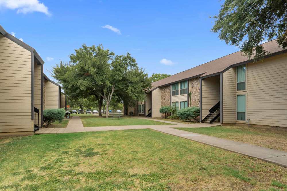 Beautiful exterior view of the apartment with green lawn at Woodland Village Apartments in Breckenridge, Texas