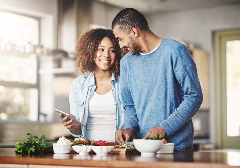 Resident couple cooking a meal together in their new home at Sofi Sunnyvale in Sunnyvale, California
