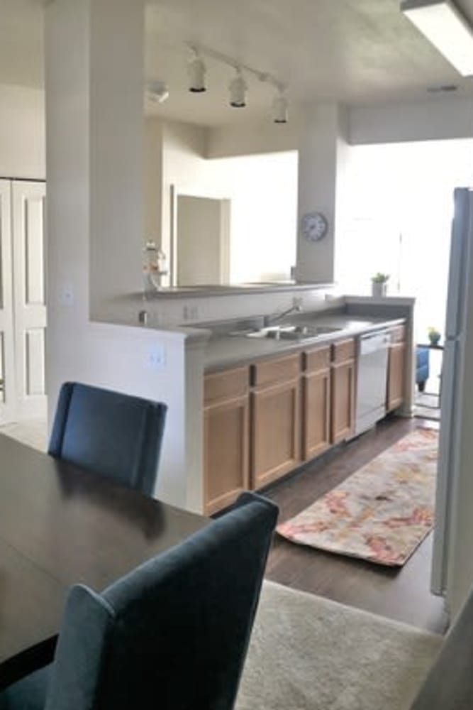 Modern kitchen with granite counters and wood style floor at Lakeshore Apartment Homes in Evansville, Indiana