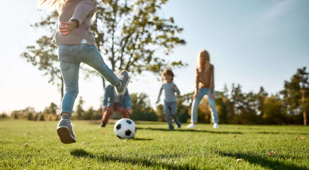 Kids playing soccer in greenspace at Dickinson Apartments in Springfield, Illinois