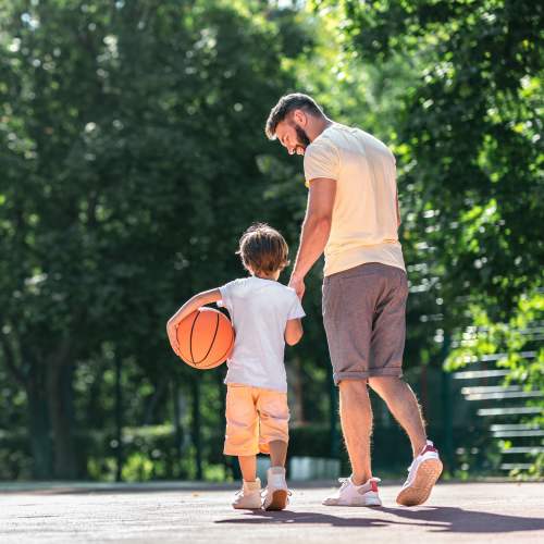 Father and son playing basket ball at Chateau Hills in Portland, Oregon