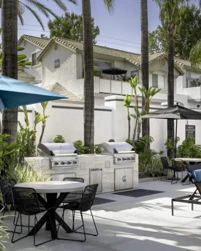 Patio with barbeque stations and tables at Las Palmas Apartment Homes, Fullerton, California