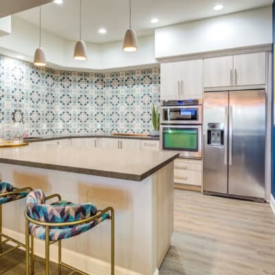 Beautiful gourmet kitchen with stainless-steel appliances in a model home at Sofi Highlands in San Diego, California