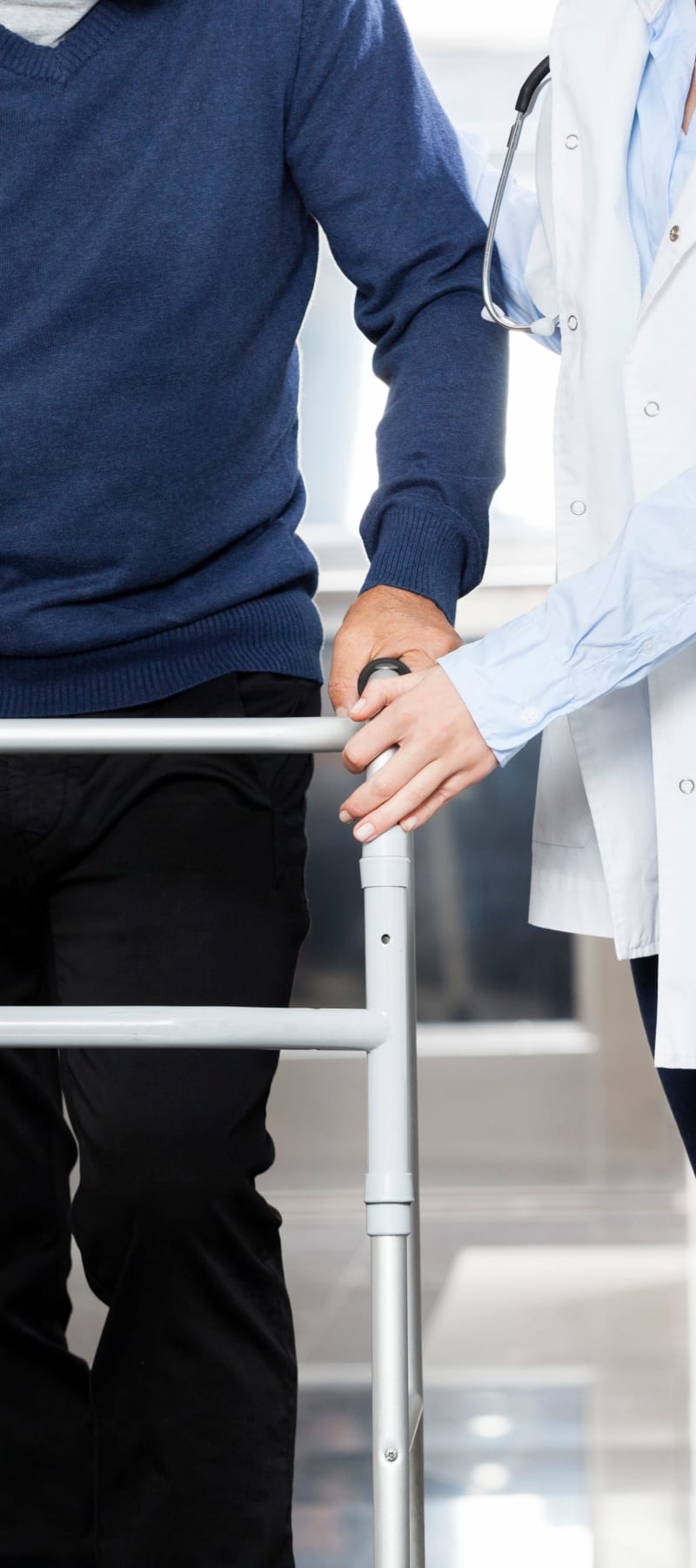 Resident in rehabilitation walking with assistance at Montello Care Center in Montello, Wisconsin