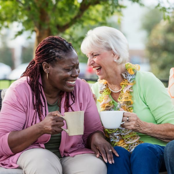 Residents enjoying a conversation over coffee at The Madison Senior Living in Kansas City, Missouri