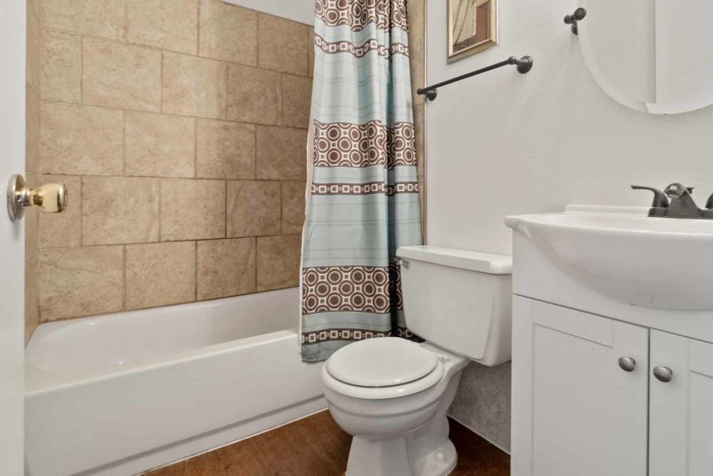 Bathroom with bathtub, toilet and sink at Woodland Village Apartments in Breckenridge, Texas
