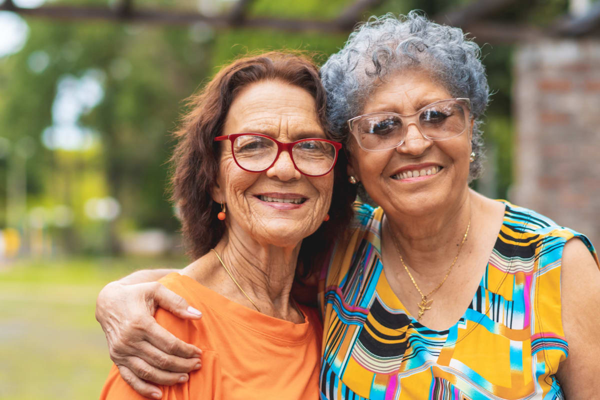 Residents smiling with an arm around each other at The Commons at Union Ranch in Manteca, California