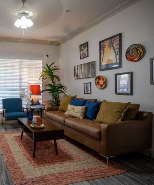 Brown leather sofa with colorful pillows at Brixton in Round Rock, Texas