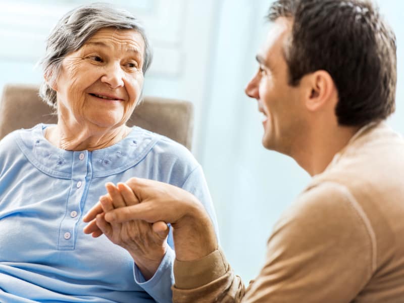 A resident talking to a CNA at Mill Creek Village Senior Living in Columbia, Missouri