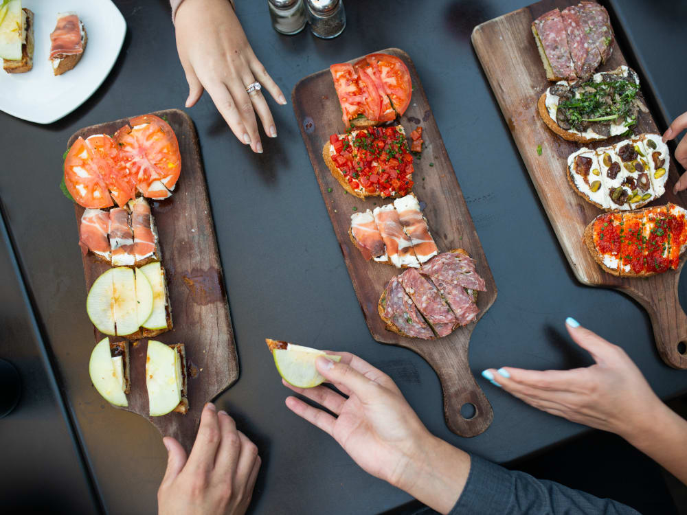 Residents enjoying delectable appetizers at a restaurant near San Hacienda in Chandler, Arizona