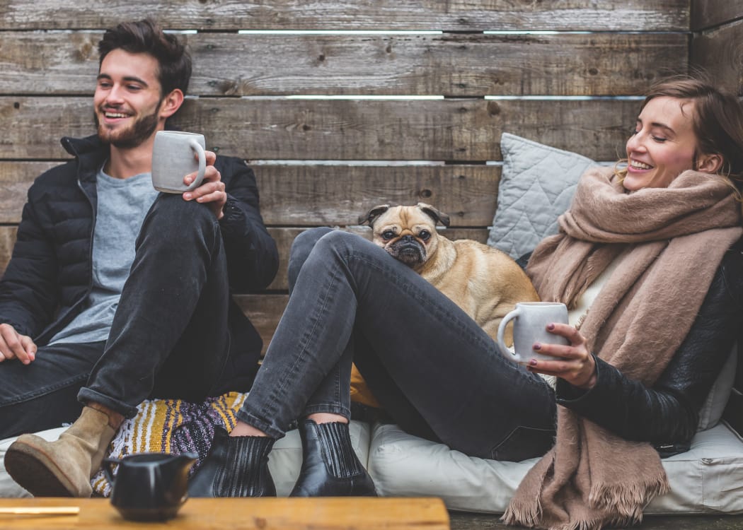 Happy woman with her dog chilling at Bella Springs Apartments