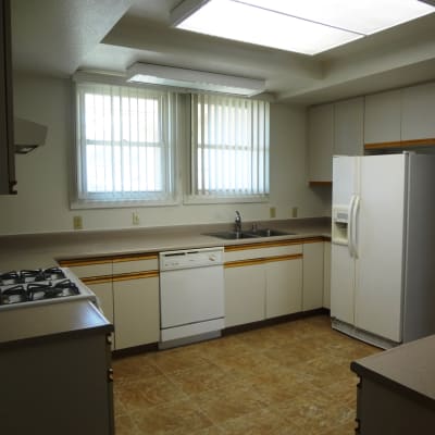 A kitchen with appliances in a home at Capeharts in Ridgecrest, California