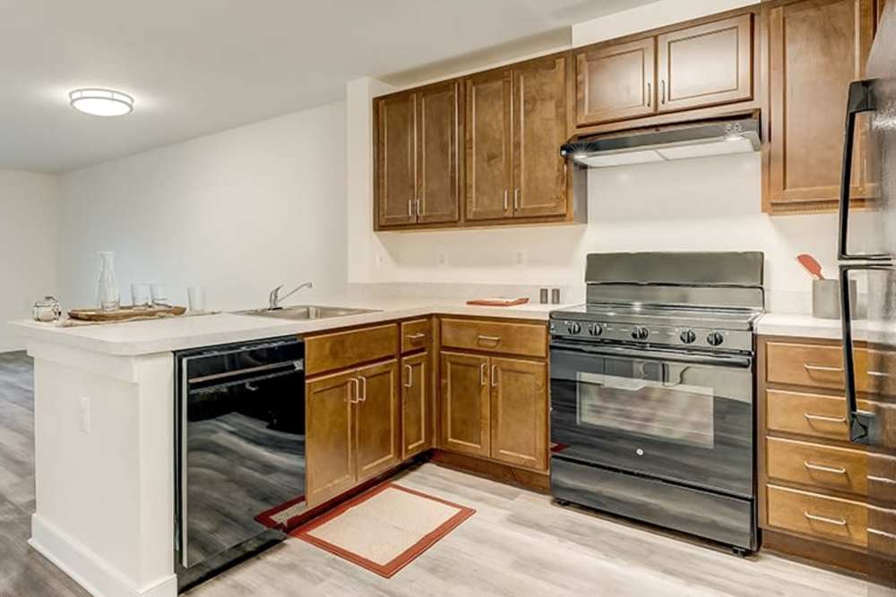 Modern kitchen with stainless steel appliances at Homes on Quaker Lane in Sandy Spring, Maryland