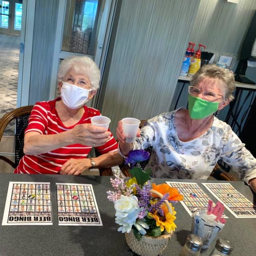 Residents playing bingo while wearing masks at Oxford Villa Active Senior Apartments in Wichita, Kansas