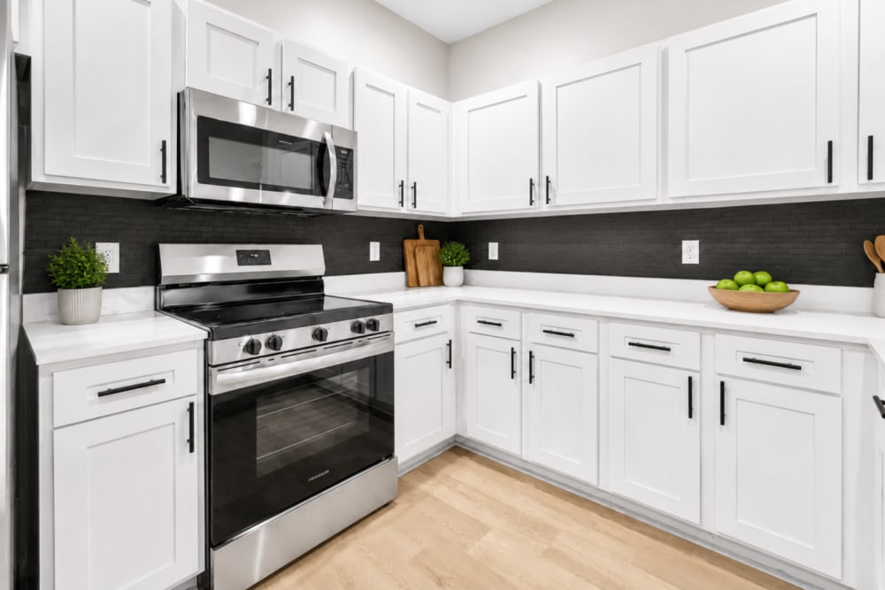 Renovated kitchen with white cabinetry at Pointe 28 in Ankeny, Iowa