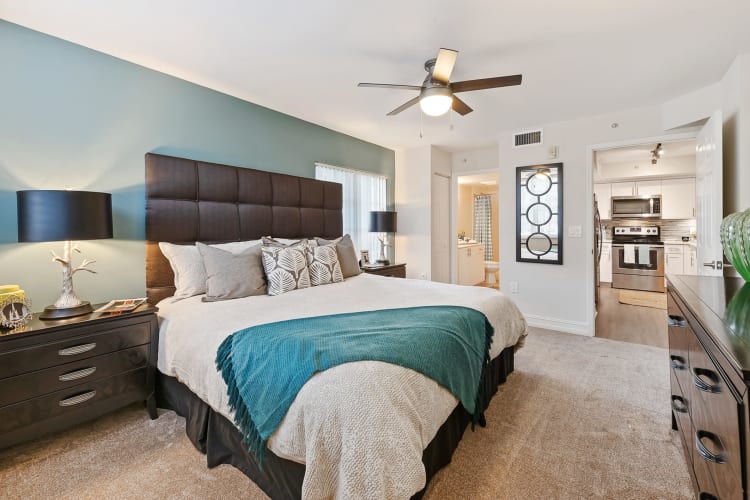 Beautiful model bedroom with a ceiling fan and plush carpeting at Crescent House Apartments in Miami Lakes, Florida