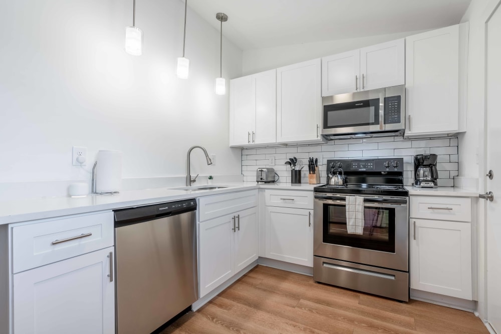 Ample natural light and quartz countertops in a model apartment's kitchen at The Motif by Morningside in Atlanta, Georgia