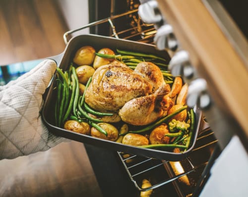 Resident cooking up something delicious in his new home's kitchen at Palm Lake Apartment Homes in Concord, California